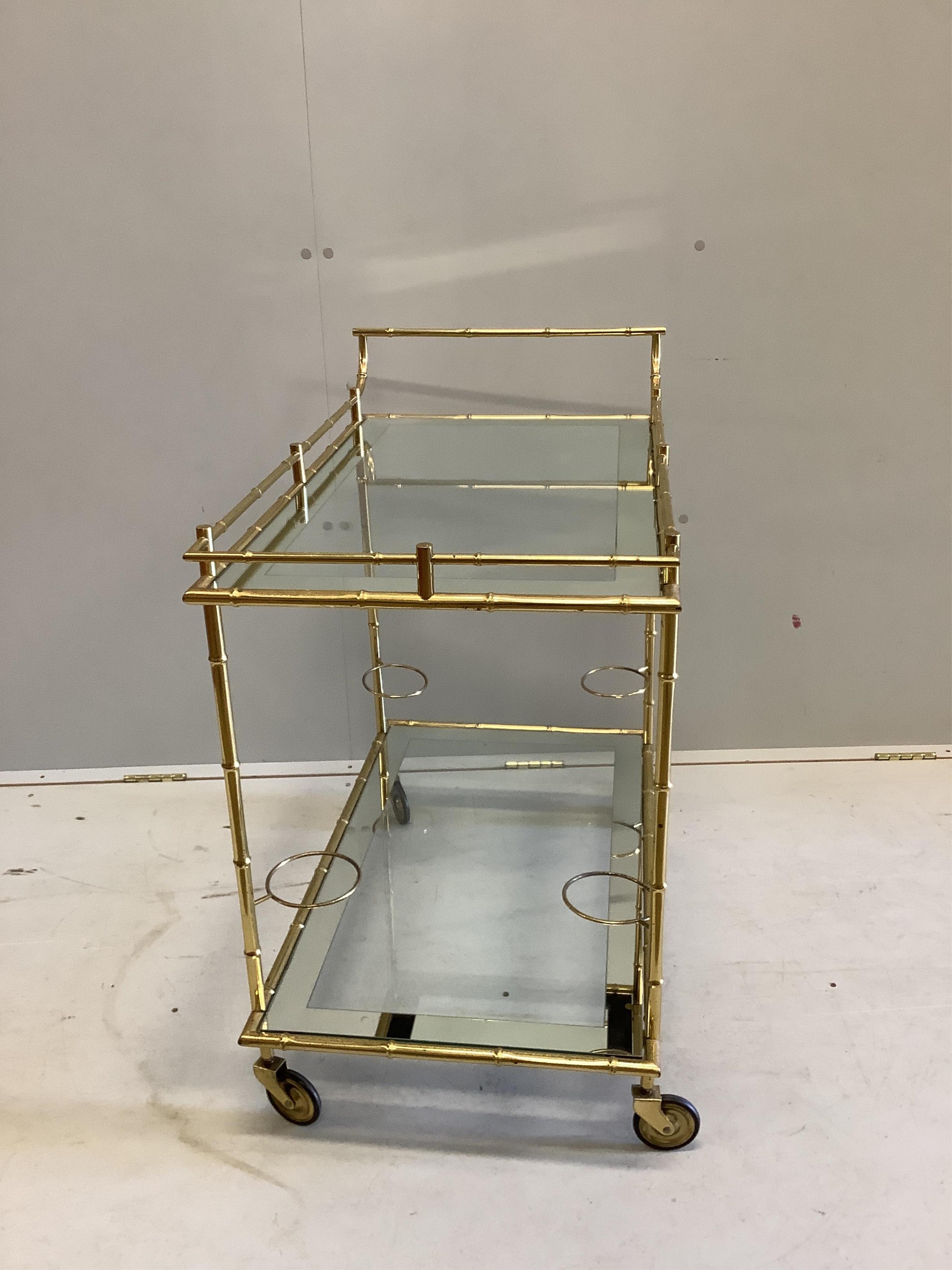 A Maison Jansen style gilt brass and glass drinks trolley, width 80cm, height 80cm. Condition - fair